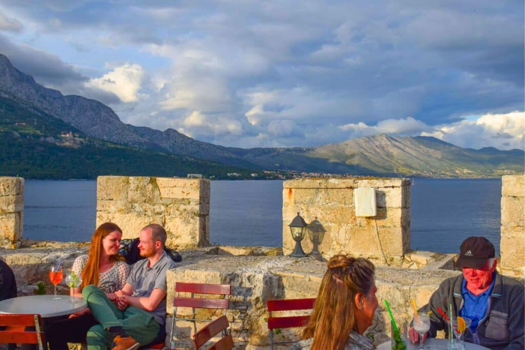 People at Massimo bar at sunset enjoying a cocktail with a sea view