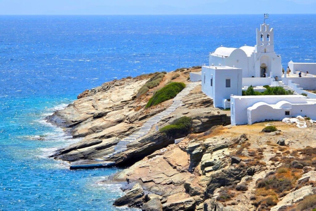 Chrisopigi Monastery perched on a rocky ledge by the sea in Sifnos Greece