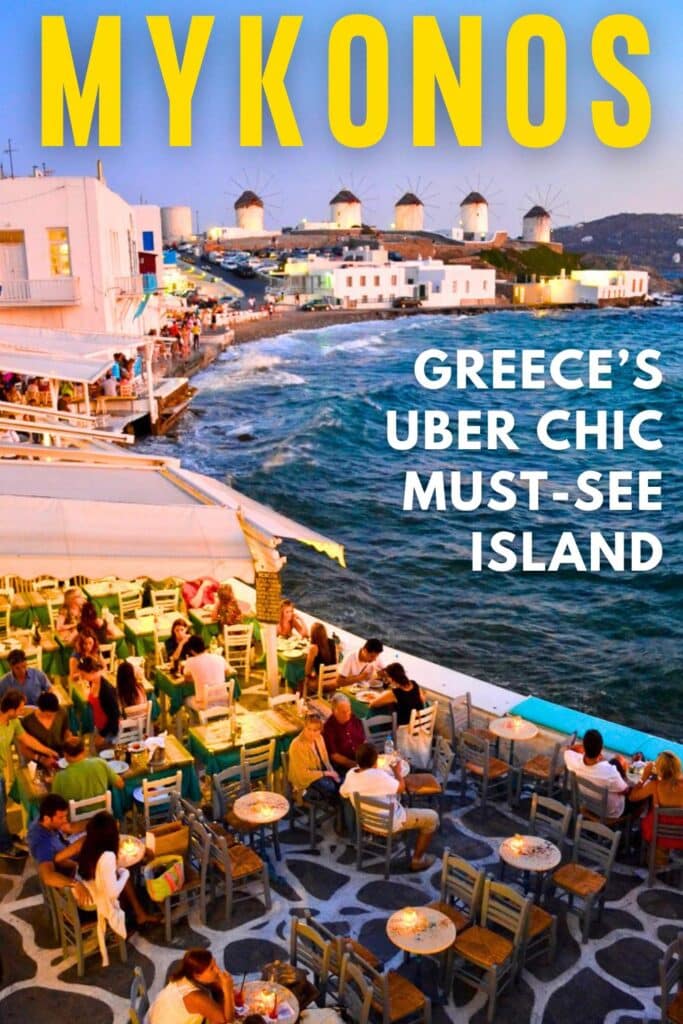 A seaside cafe full of people at dusk on Mykonos Island Greece overlooking the windmills