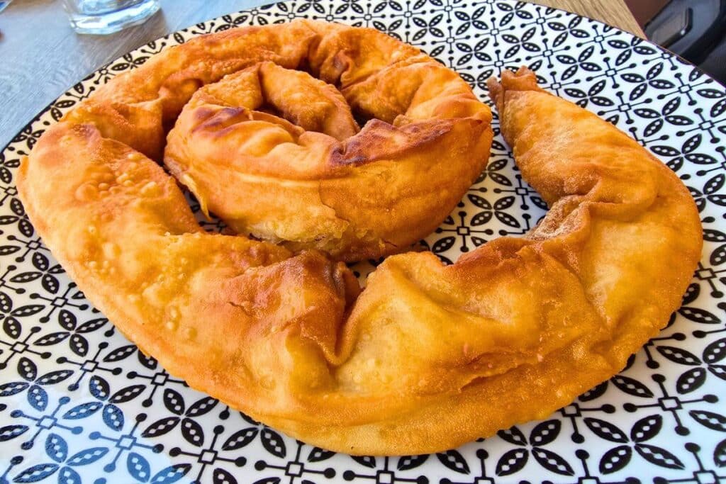 A spiral shaped crispy dough pie filled with cheese