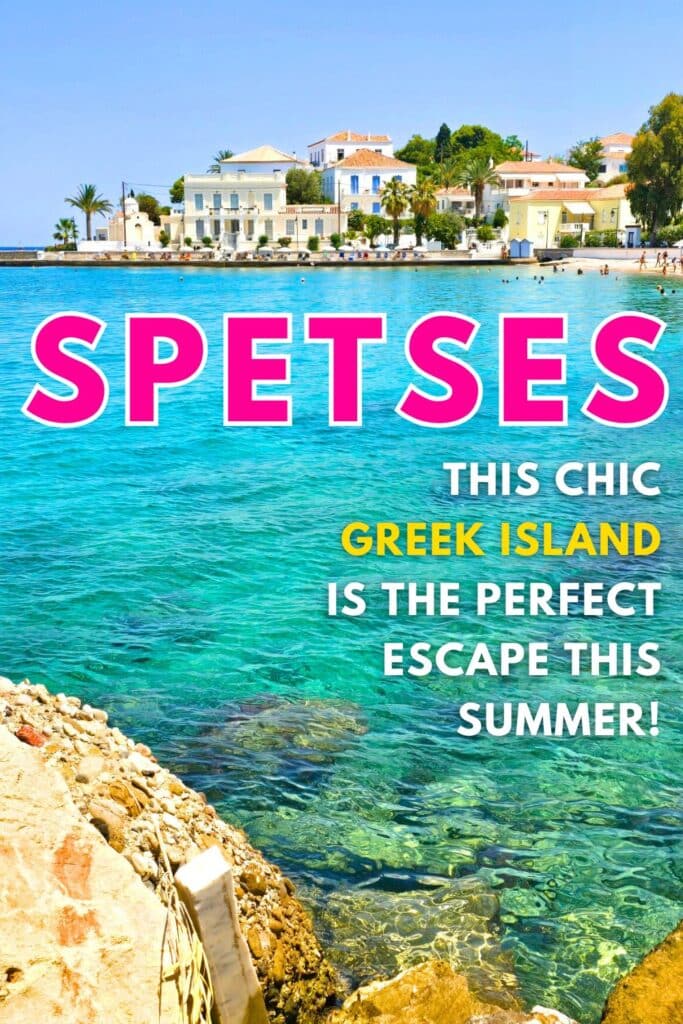 Image of transparent turquoise water on a rocky shoreline with neoclassical mansions lining the shore line. Text reads Spetses, this chic greek island is the perfect escape this summer.