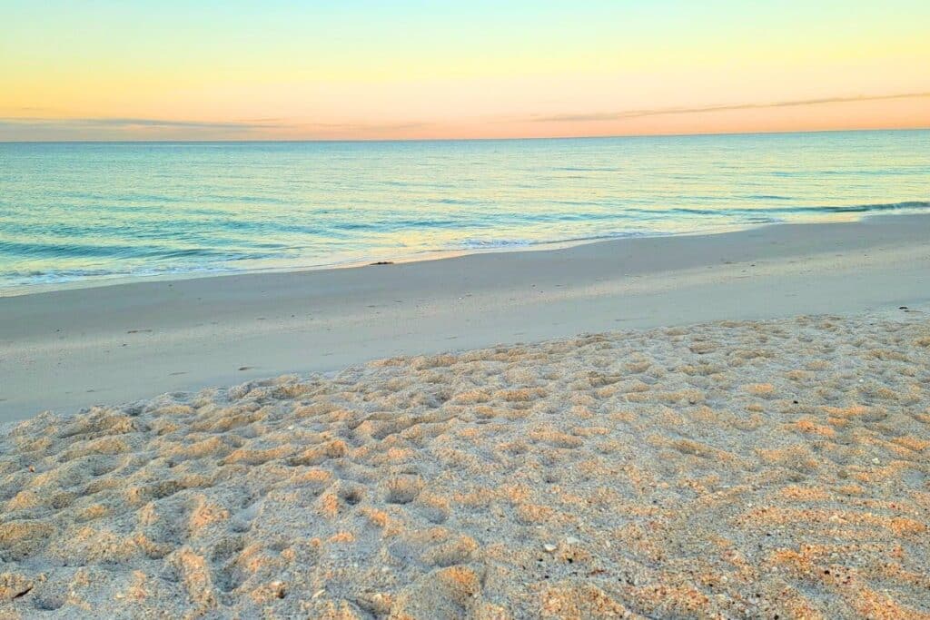 Pink sky at sunrise on the beach in Casey Key Florida