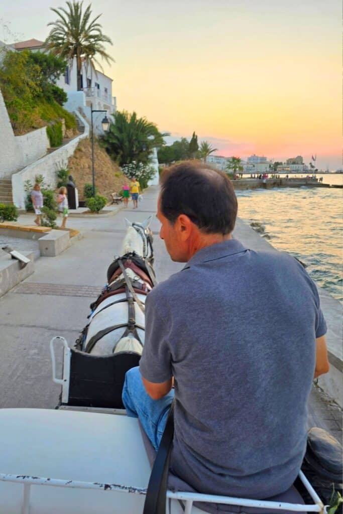 A horse-drawn carriage ride along the sea at sunset